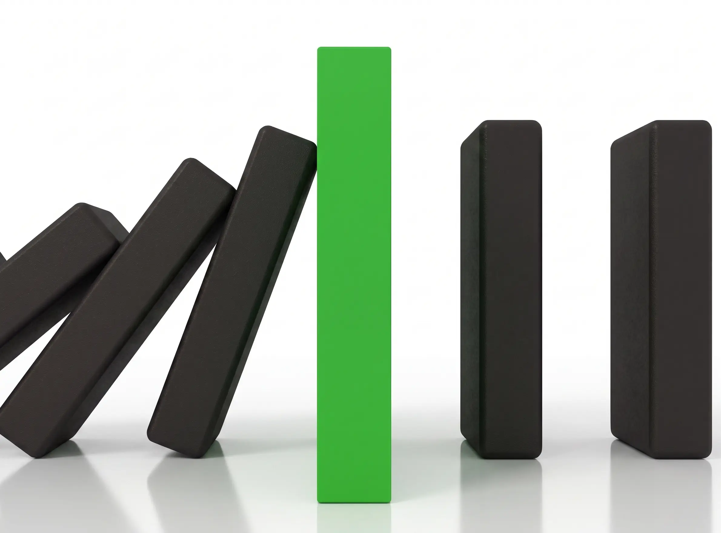 A green domino standing firm, stopping a line of falling black dominoes